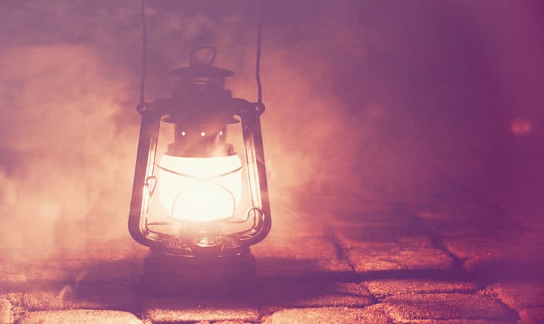 Image of a gas lantern sitting on tile in a pink mist.