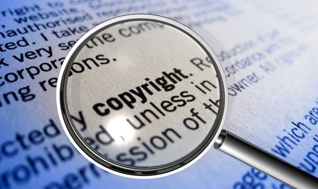 9 Unexpected Places to Find Ancestor Photos 7 A magnifying glass hovering over the word "copyright."