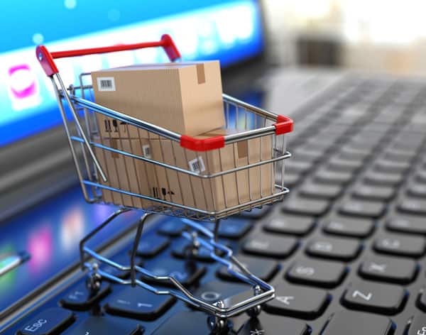 Desperately Seeking Genealogy Software: A Guide to Finding Your Perfect Match 3 A tiny shopping cart filled with cardboard boxes sitting on a laptop computer keyboard.