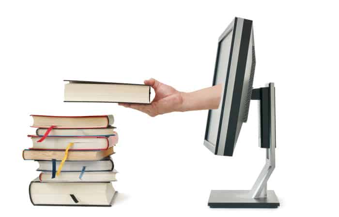 Where to Find Free Family History Books Online 2 A hand with a book coming out of a computer monitor to illustrate downloading digital books.