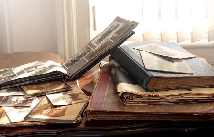 Review: Planning A Future For Your Family's Past 2 A table with photo albums, scrapbooks, books, and old newspapers.