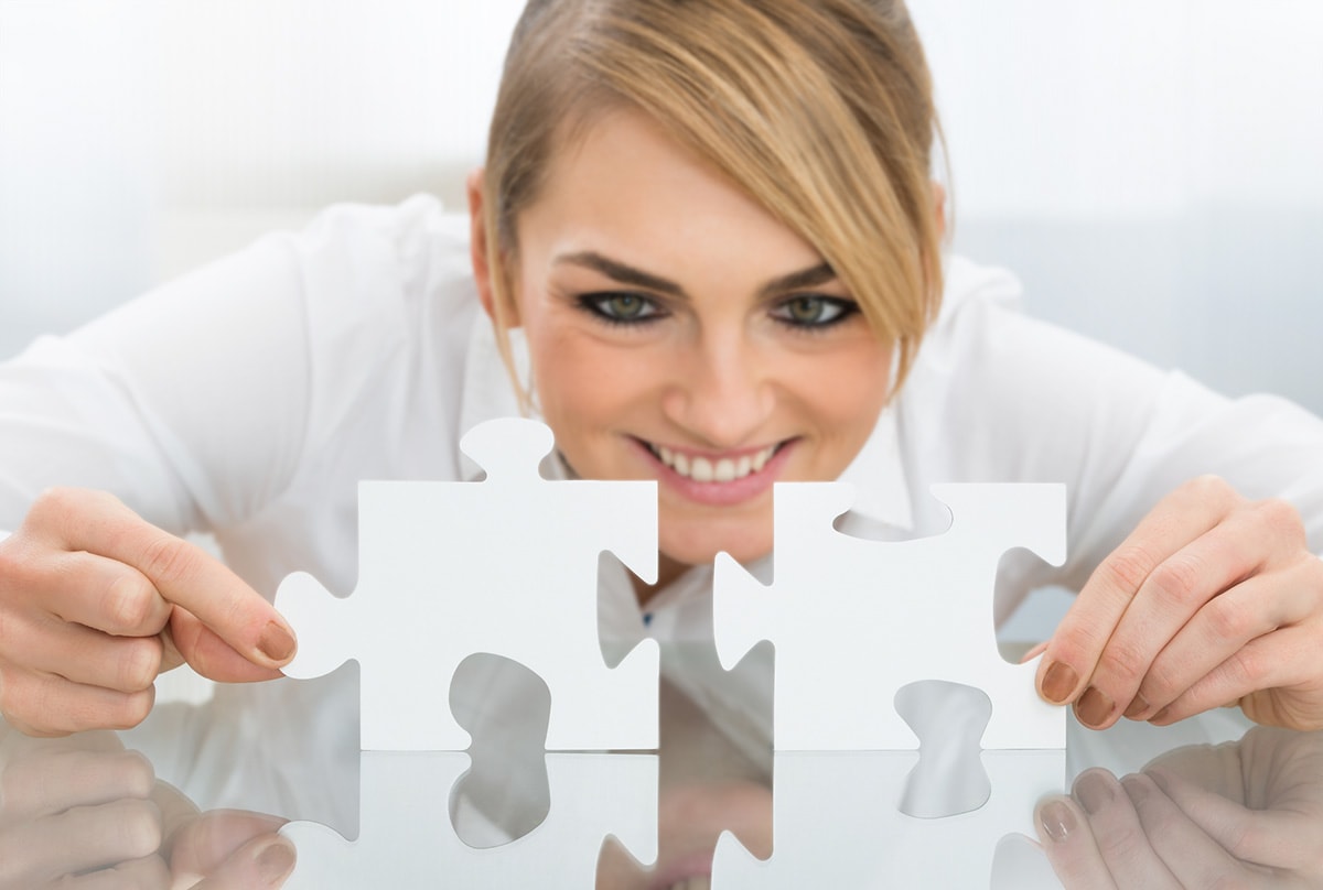 Genealogy Blog Party: How You Did It - smiling woman putting together two white puzzle pieces