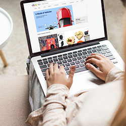 Lectures 21 Image of a woman with a laptop on her lap searching eBay.