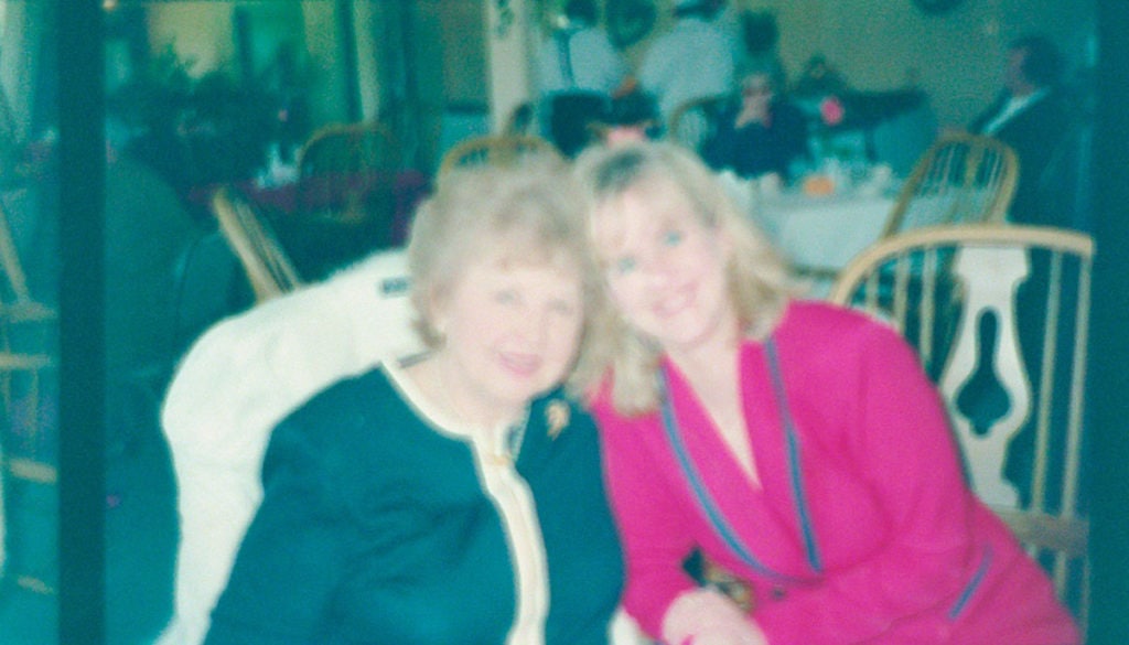 5 (Mostly) Free Apps to Scan Film Negatives With Your Phone 15 Color image scanned from a film negative with the FilmLab app: two women, an older red-haired woman in a black and white suit next to a younger blonde woman in a red suit with dark blue trim.