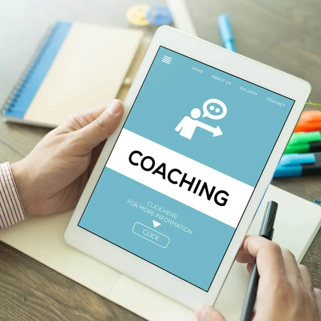 Services 2 Image of a man's hands holding an iPad with a coaching website displayed.