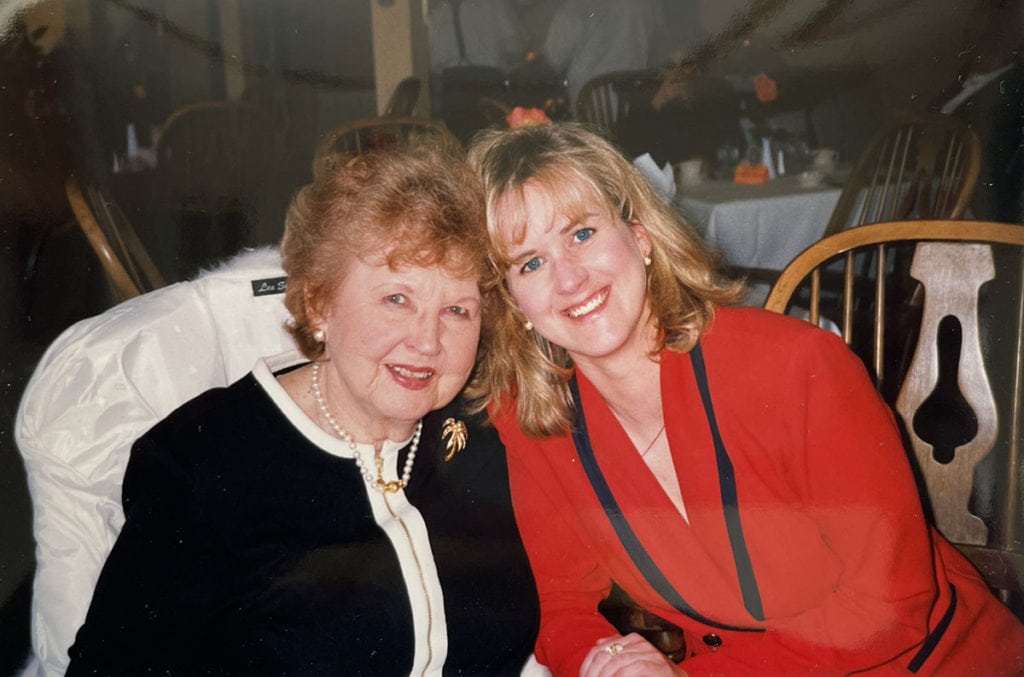 5 (Mostly) Free Apps to Scan Film Negatives With Your Phone 2 Image of an older red-haired woman in a black and white suit next to a younger blonde woman in a red suit with dark blue trim.
