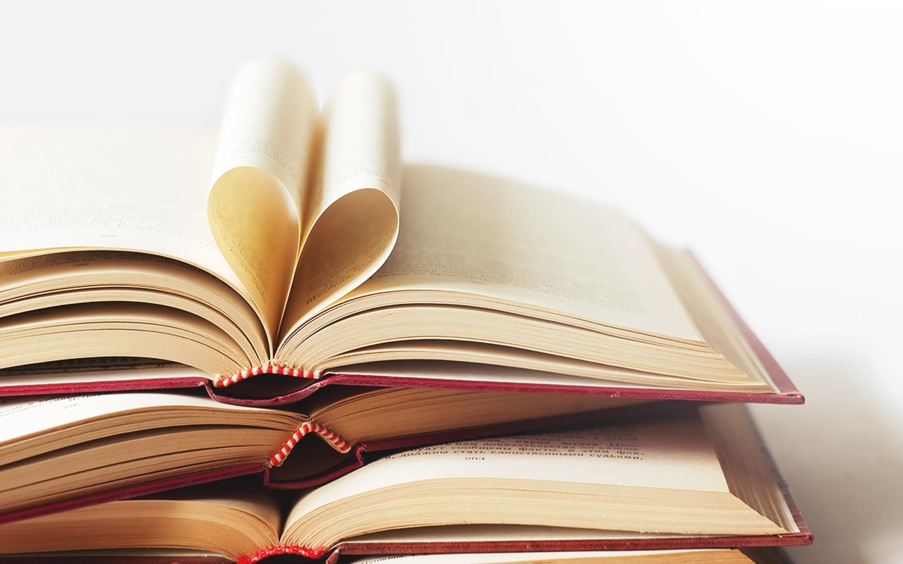 Image of a book with pages folded to make a heart symbolizing love stories