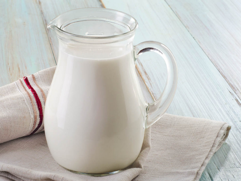 Making the Perfect Irish Soda Bread 3 Image of buttermilk in a glass jug sitting on a kitchen towel.