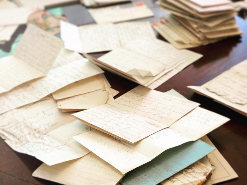 5 Top Tips for Using eBay for Family History 2 Dozens of old, handwritten letters stacked on a brown table.