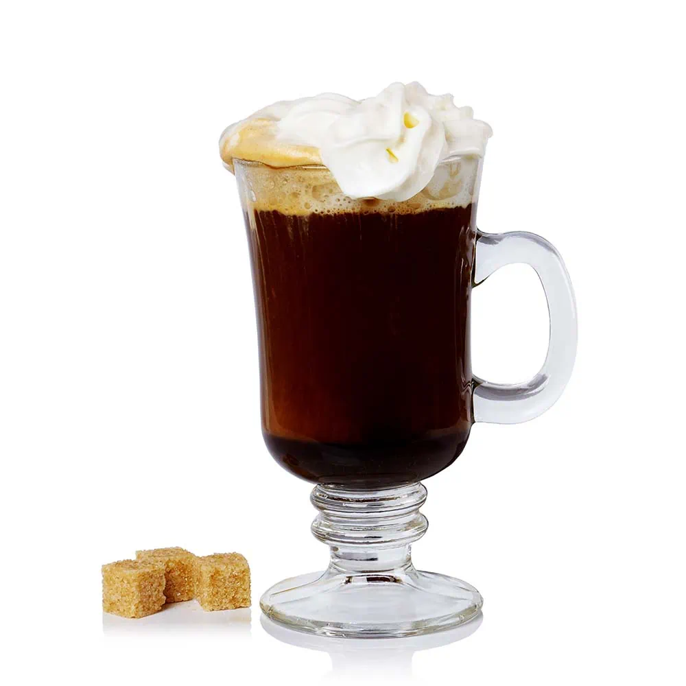 About 18 A glass of Irish coffee with brown sugar cubes on a white background.