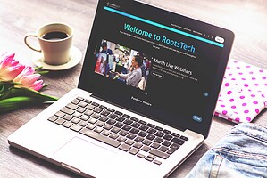 Laptop displaying RootsTech website with flowers