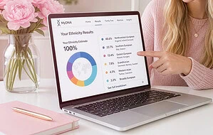 Woman's hand pointing at a laptop computer displaying dna ethnicity estimates